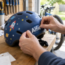 Applying personalised helmet name decals with the name Alfie to a bike helmet