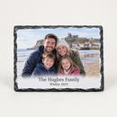 Personalised photo slate printed with a happy family photo on a beach and the text The Hughes Family and Whitby 2025, on a plain background