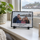 Personalised photo slate, standing on a cosy living room windowsill next to a small potted plant