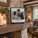 Personalised square photo slate, displayed on a stone fireplace mantelpiece in a cosy UK cottage living room with candles