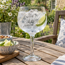 Personalised gin balloon glass with the name Sophie with gin and tonic in a summer garden