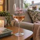 Personalised wine glass with the name Mum on a side table on a relaxing evening
