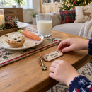 Child leaving a personalised Santa's magic key beside a mince pie and carrot