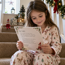 Child reading her personalised Christmas elf arrival kit letter