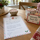 Personalised Christmas elf arrival kit set up on a breakfast table