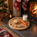 Personalised Christmas Eve board with treats for Santa by the fireplace