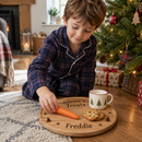 Child setting out a personalised Christmas Eve board for Santa