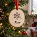 Personalised wooden tree decoration with the name Mia on a Christmas tree