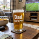 Personalised pint glass with the name Dad on a living room table on match day
