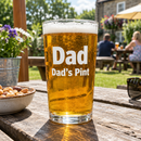 Personalised pint glass with the name Dad with beer on a garden table