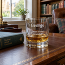 Personalised whisky tumbler with the name George on a study desk