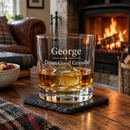 Personalised whisky tumbler with the name George with whisky by a fireplace