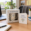 Mug gift box on an office desk as a colleague gift