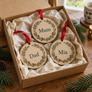 Set of three personalised wooden tree decorations in a gift box