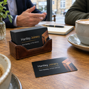 Metal business cards in a card holder at a meeting