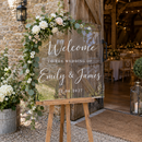 Personalised acrylic wedding welcome sign at a barn wedding entrance