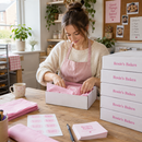 Small business owner packing orders in custom printed mailer boxes