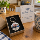 Personalised photo keyring: a small open gift box with a personalised hexagonal metal photo keyring printed with a grandad and grandson photo and the words 'Love you Grandad'