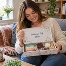 Woman opening a personalised letterbox gift box hug in a box