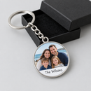 Personalised photo keyring: round silver metal keyring printed with a family seaside photo and the name 'The Wilsons', shown with its gift box