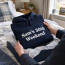 Personalised adult hoodie with custom text being unwrapped as a birthday gift