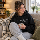Woman relaxing at home in a personalised adult hoodie with custom text