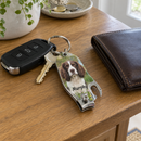 Personalised bottle opener keyring: a personalised 3-in-1 nail clipper bottle opener keyring printed with a photo of a springer spaniel and the name 'Murphy' on a set of car keys resting on a hallway table