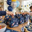 Personalised party favour boxes on a kids birthday party table