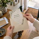 Opening a personalised wedding invitation from the post