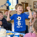 Boy wearing a personalised 6th birthday age t-shirt at his party
