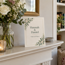 Personalised wedding invitation propped on a mantelpiece