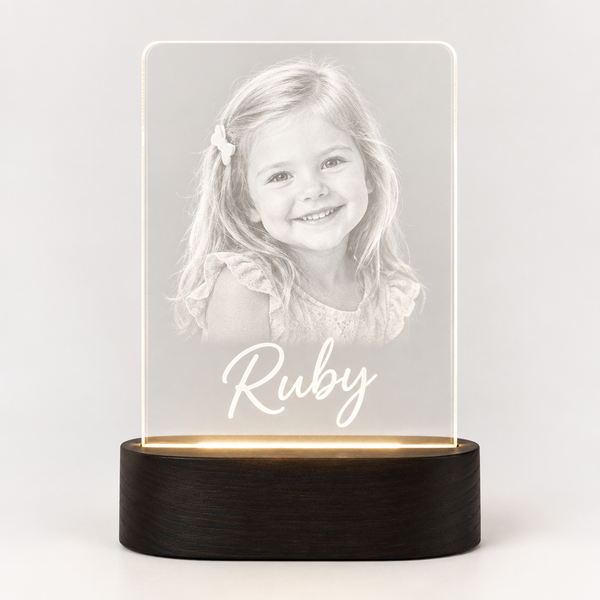 Personalised LED acrylic night light glowing with a photo and the name Ruby