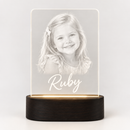 Personalised LED acrylic night light glowing with a photo and the name Ruby