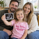 Girl announcing a pregnancy in a personalised big sister t-shirt