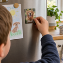 Child placing a personalised acrylic photo fridge magnet on the fridge