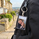 Personalised acrylic photo keyring on a backpack zip