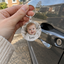 Hand holding a personalised acrylic photo keyring with the name Leo
