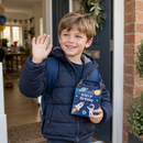 Child leaving a party with a personalised party favour box