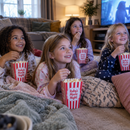 Kids at a sleepover with personalised popcorn boxes