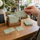 Rounded corner business cards in a holder on a shop counter