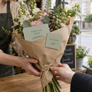 Rounded corner business cards tucked into a bouquet