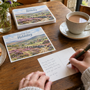 Custom printed postcards being written at a café table