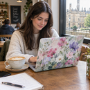 Student using a laptop with a custom photo laptop skin in a cafe