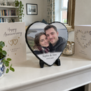 Personalised heart photo slate, on a white mantelpiece with anniversary cards around it in a UK living room