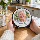 Personalised round photo slate, being held gently in a woman's hands at a kitchen table