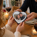 Personalised heart photo slate, being given as an anniversary gift across a restaurant-style candlelit dinner table at home