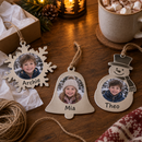 Personalised metal Christmas decorations in snowflake, bell and snowman shapes with children's photos and the names 'Archie', 'Mia' and 'Theo'
