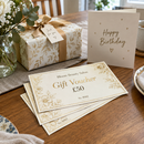 Numbered gift vouchers with a birthday gift on a table