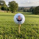 Personalised printed golf ball on a tee on a golf course