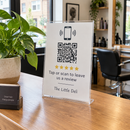 Tap and scan review stand on a salon reception desk